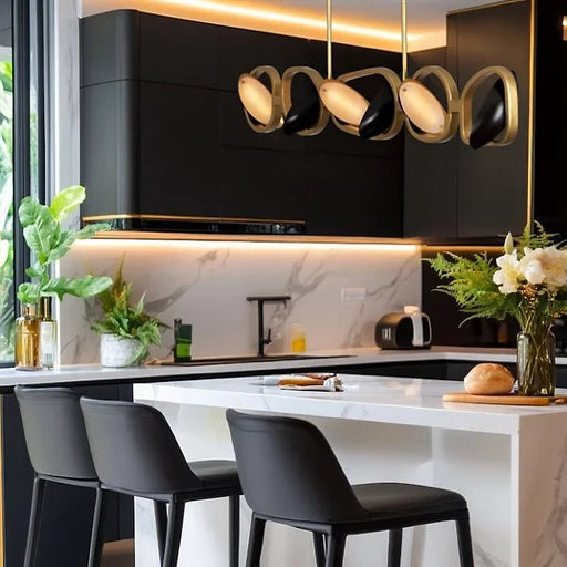 Kalco Modern linear suspension pendant light with gold and black finish on display over kitchen counter and against black cabinets. Can be adjusted to direct light where needed.